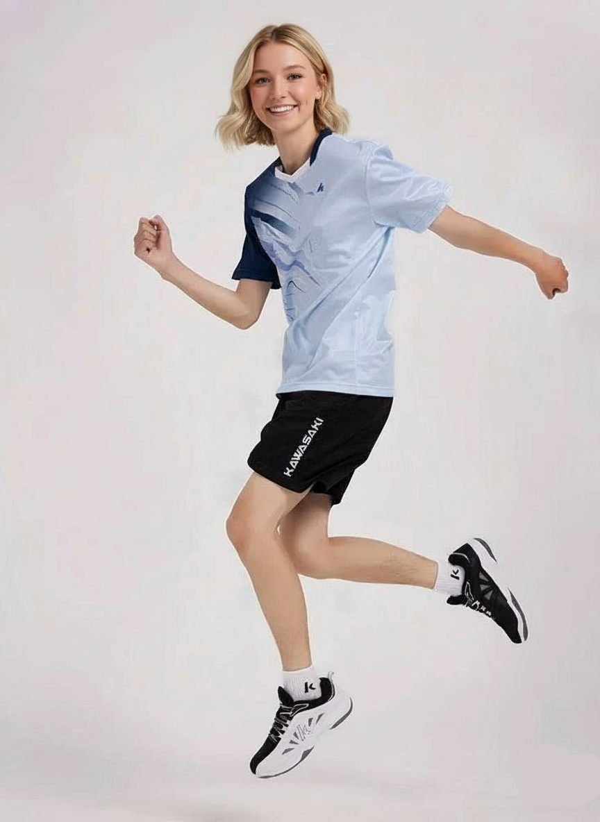 Person wearing a light blue and navy athletic outfit with black shorts on a white background