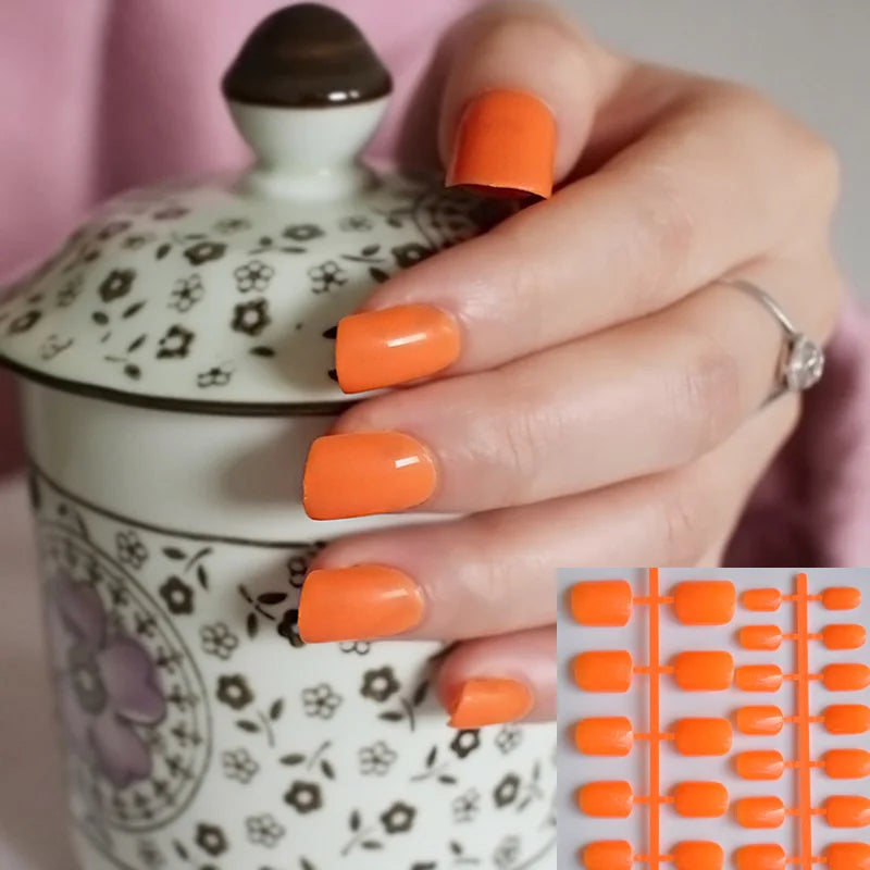 Hand with bright orange nail polish holding a patterned ceramic container, with a close-up of nails inset.