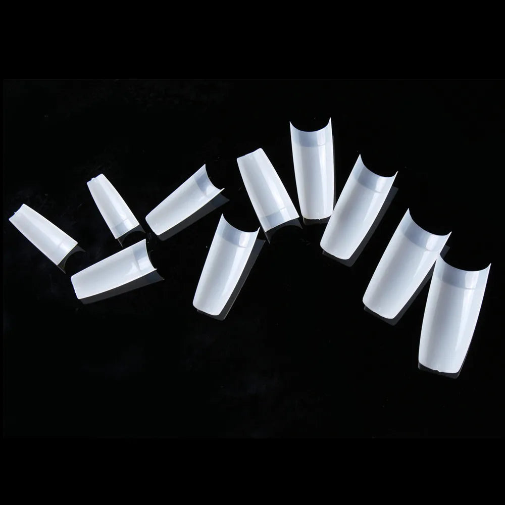 Set of white cylindrical containers with black caps on a black background