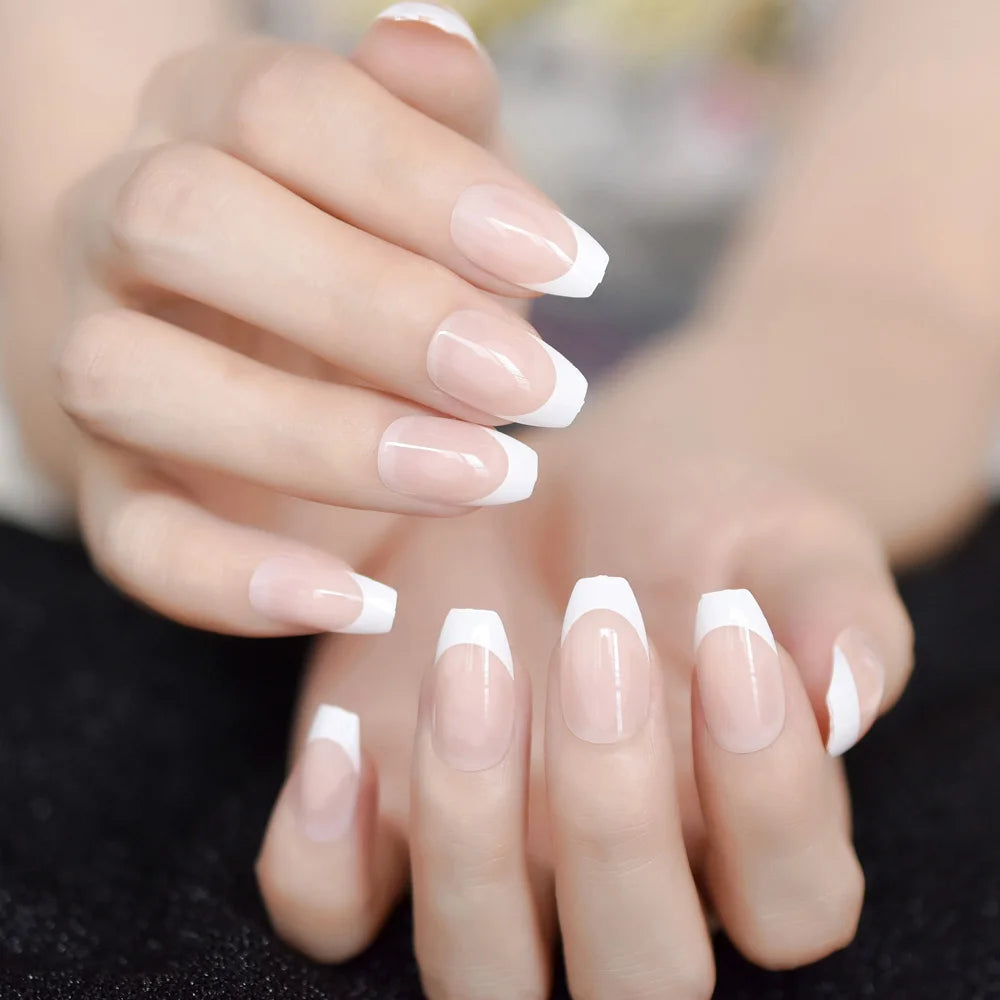 Close-up of hands with French manicure on a blurred background