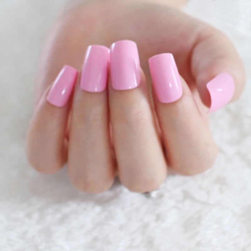 Close-up of a hand with pink nail polish on a white background