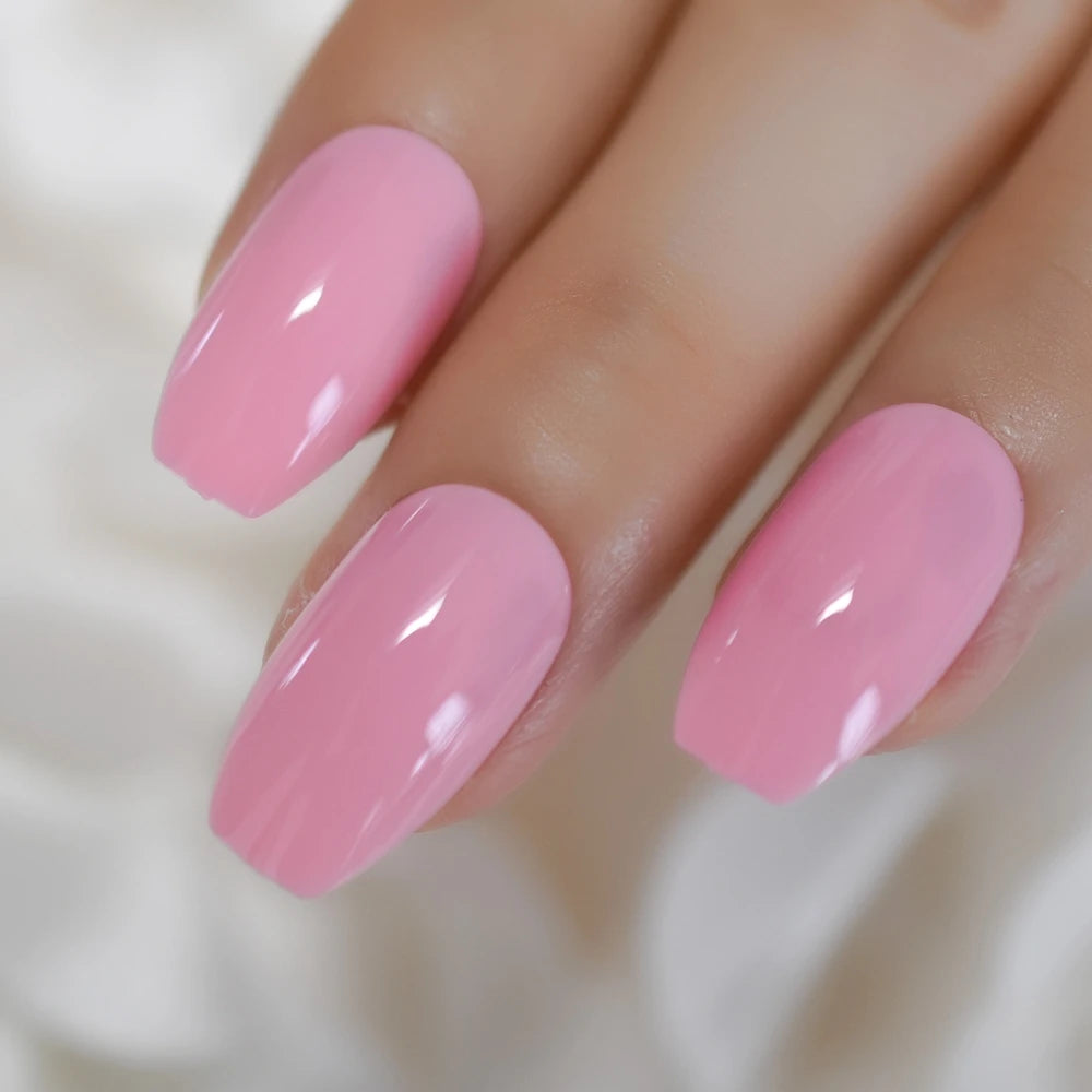 Close-up of a hand with pink nail polish on a neutral background