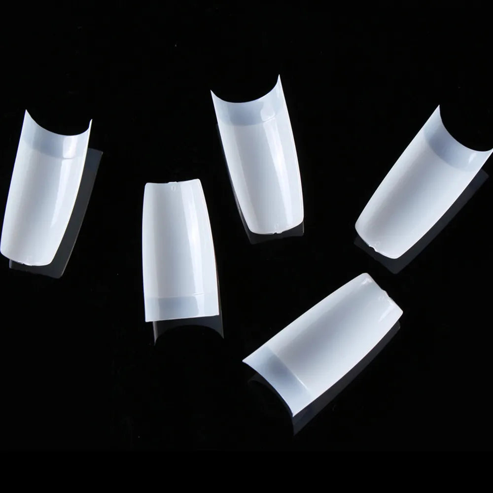 Set of white nail tips on a black background