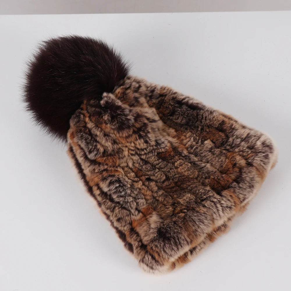 A close-up of the knit hat with the Rex rabbit fur pom-pom, showcasing its texture and luxurious look.