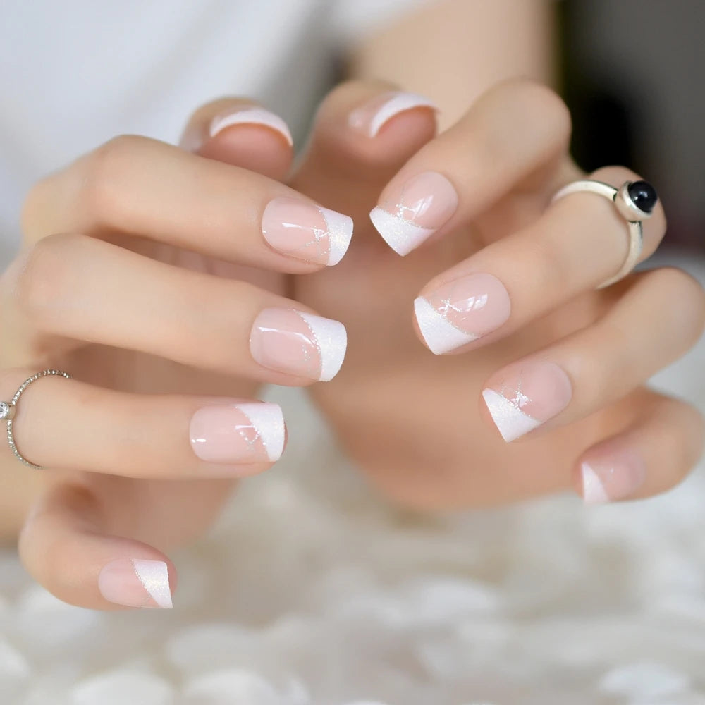 Close-up of hands with French manicure on a blurred background