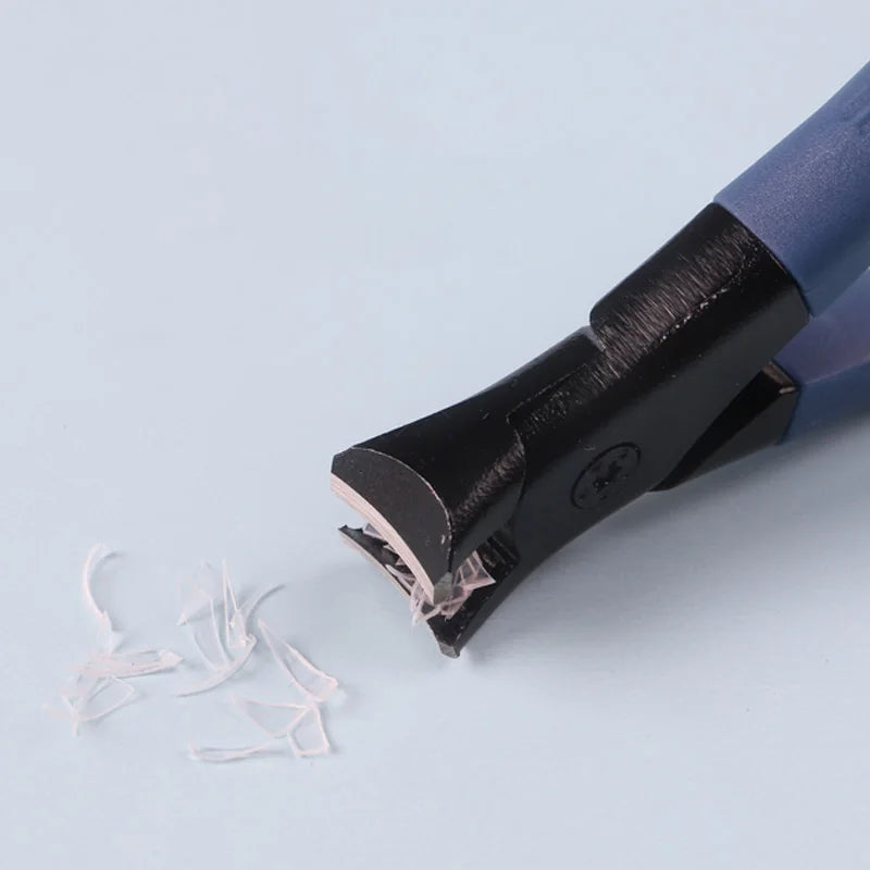 Black hair clipper on a light blue background with hair strands nearby