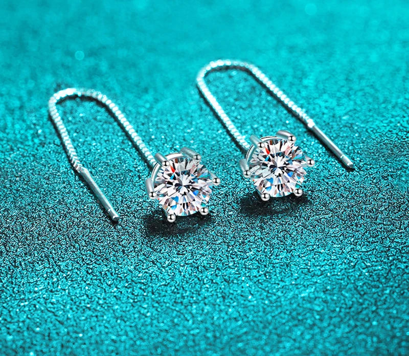 A woman wearing the white gold plated moissanite drop earrings with tassel detail.

