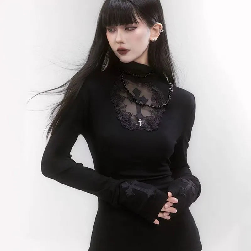 Woman wearing a black outfit with lace details and long gloves against a white background.