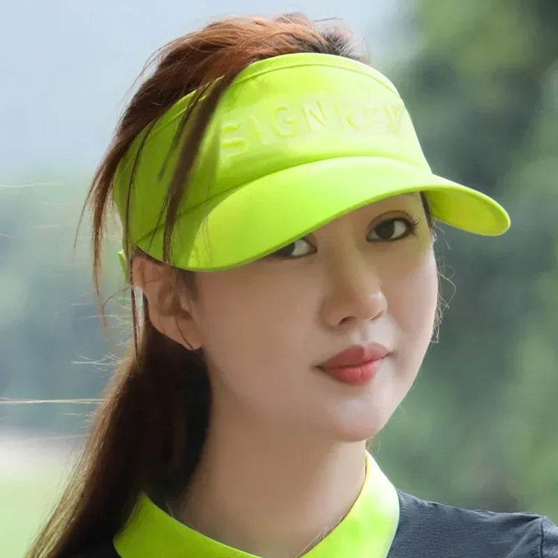 The golf visor laid flat on a table.

