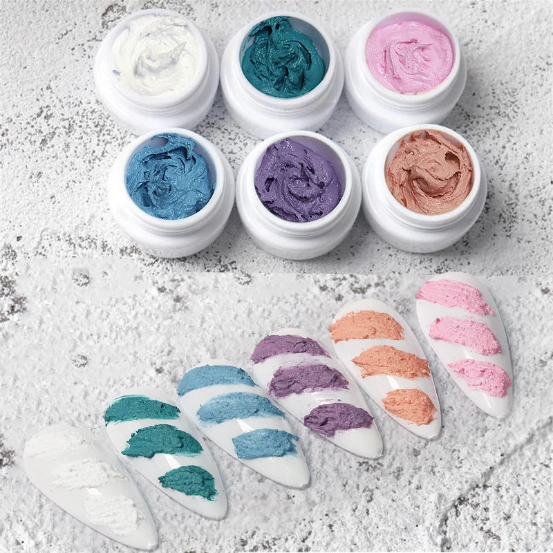 Set of small jars with colorful substances on a textured surface