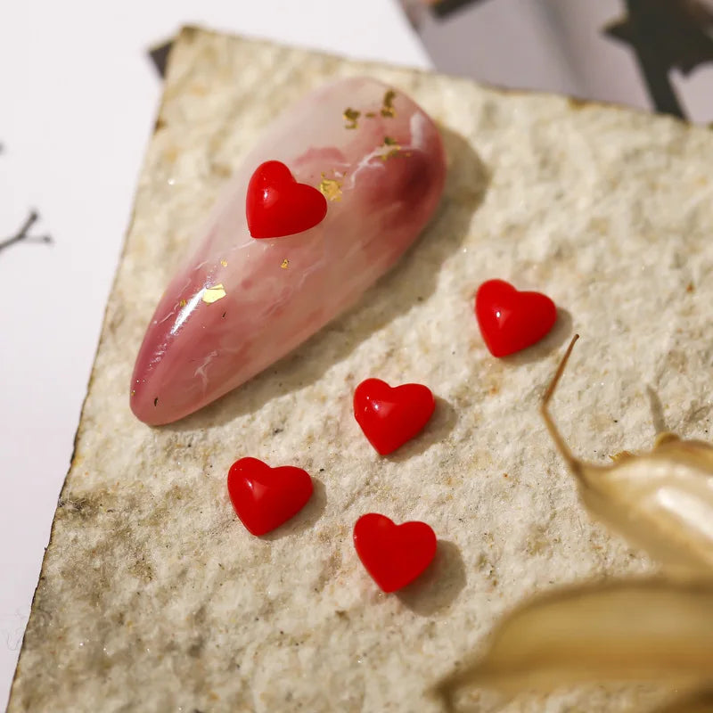Red heart-shaped objects on a textured surface