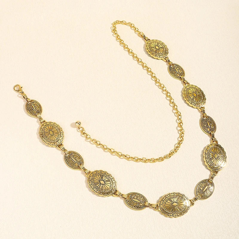 Close-up of the carved circular details of the metal waist chain.
