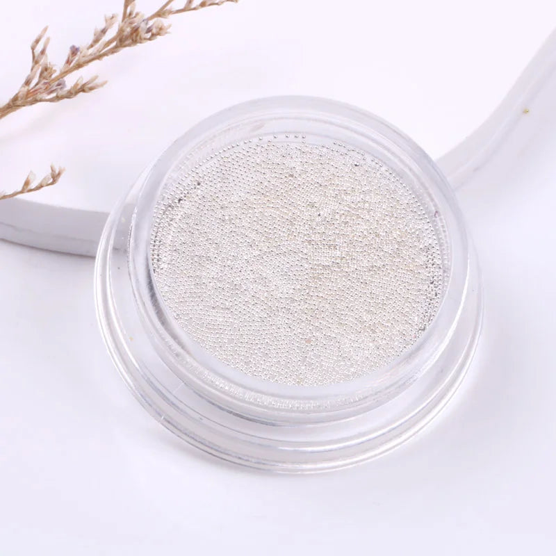 Silver glitter powder in a clear container on a white background