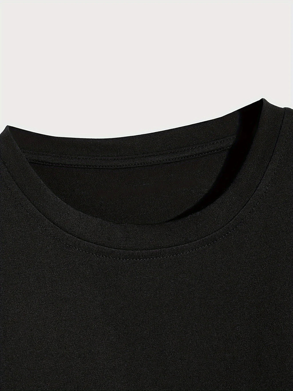 Close-up of a black t-shirt collar on a light gray background