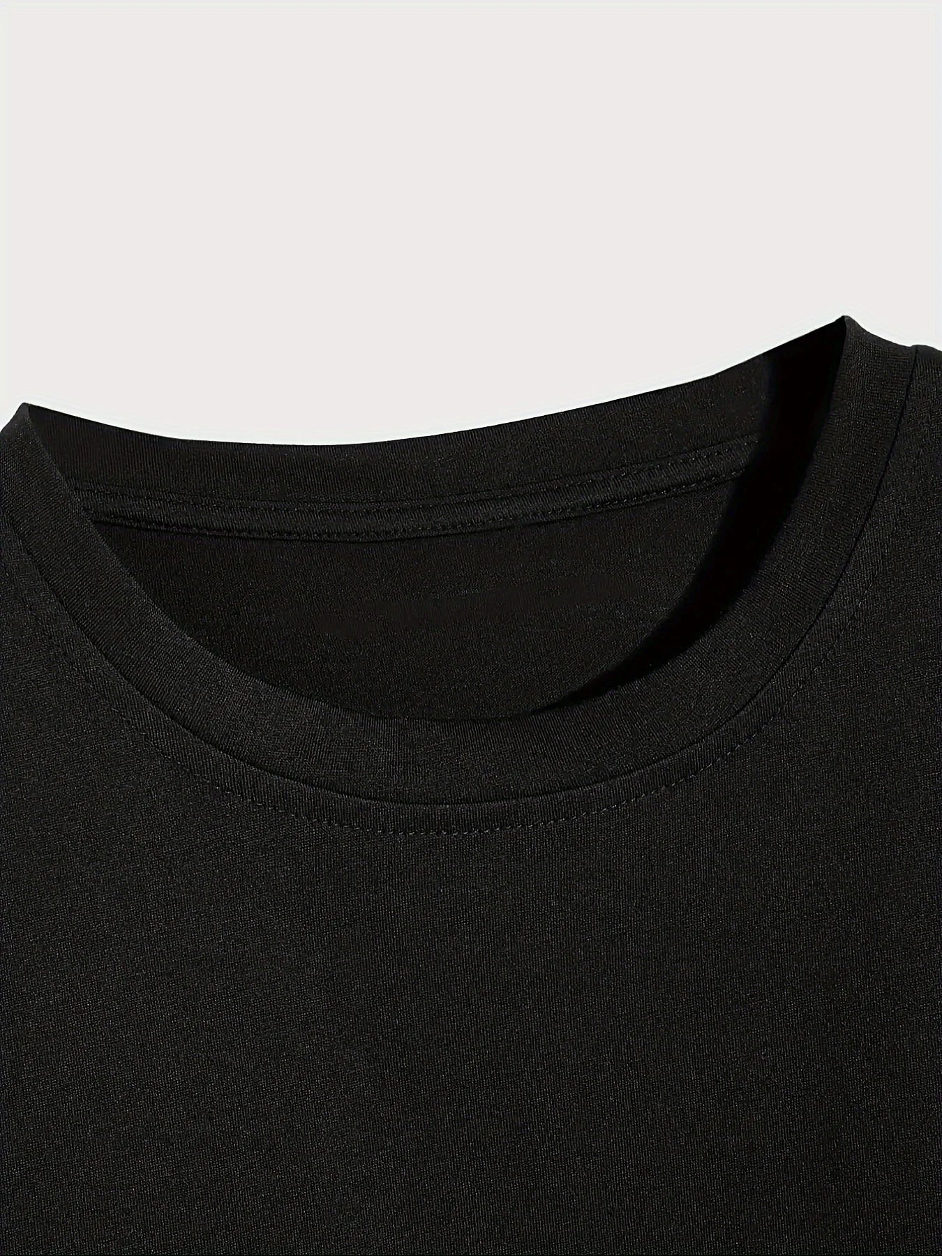 Close-up of a black t-shirt collar on a light gray background